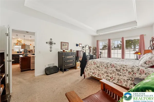 a bedroom with a large bed and a dresser
