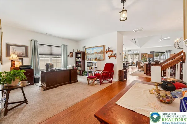 a living room filled with furniture gym equipment and a large window