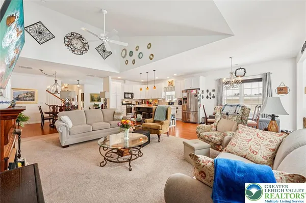 a living room with furniture kitchen view and a table