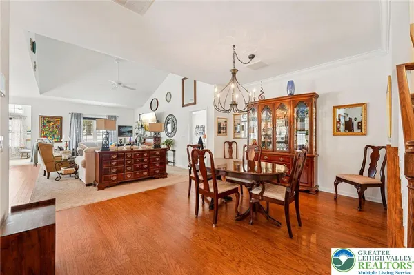 a living room with furniture wooden floor and a floor to ceiling window