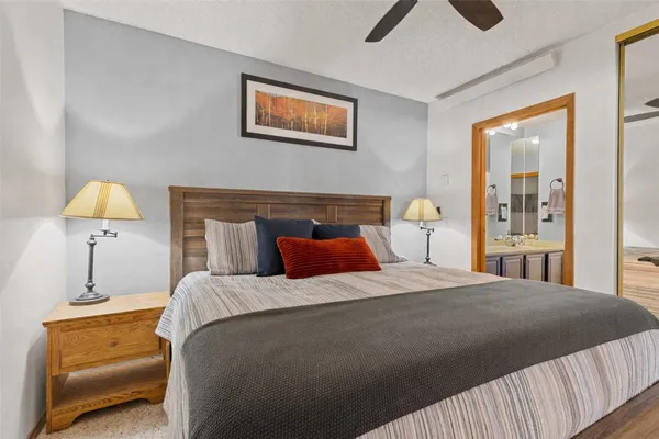 a bedroom with a bed and a lamp on table