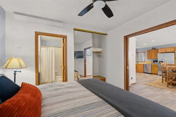 a bedroom with a bed and a chandelier