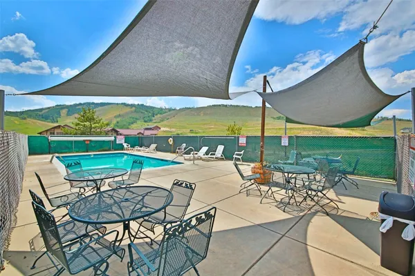 a view of a house with backyard and sitting area