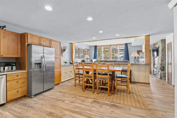 a dining area with furniture and wooden floor