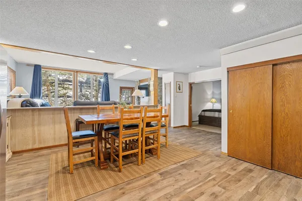 a dining room with furniture and a floor to ceiling window