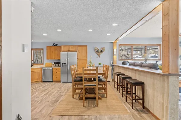 a kitchen with stainless steel appliances kitchen island granite countertop a refrigerator and cabinets