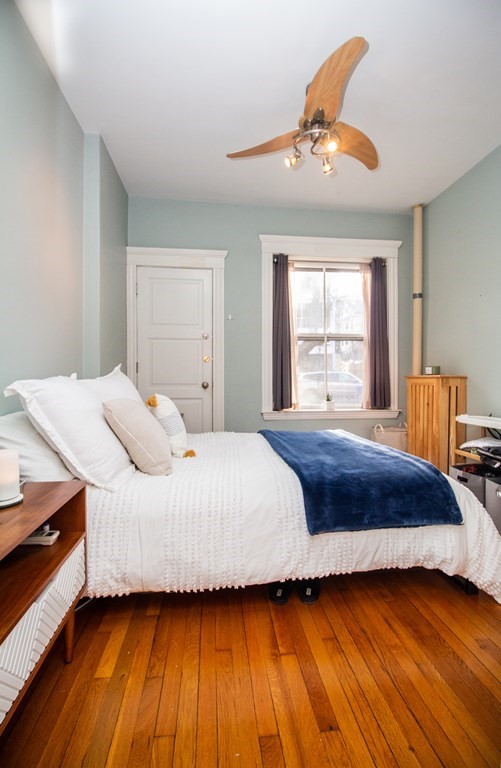 34 Winchester Street, Unit 2 Brookline, MA 02446 - Photo 11 of 14 a bedroom with a bed and wooden floor