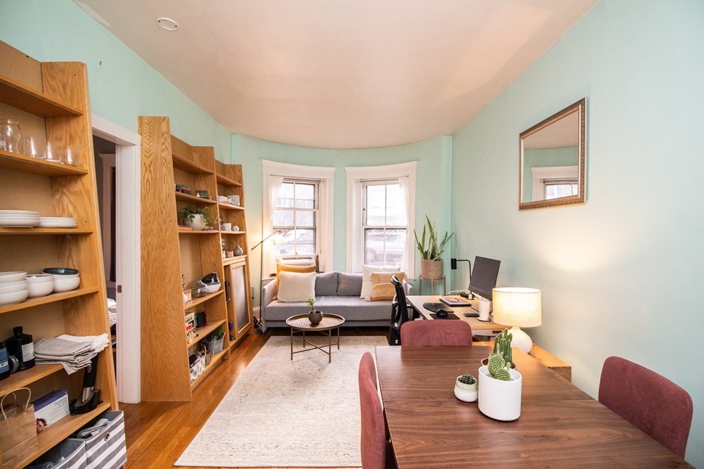 34 Winchester Street, Unit 2 Brookline, MA 02446 - Photo 4 of 14 a living room with furniture a rug and a book shelf