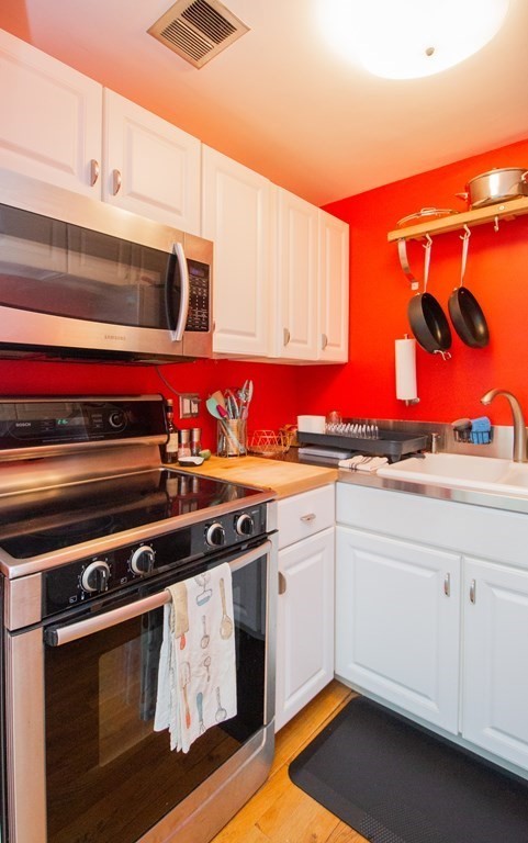34 Winchester Street, Unit 2 Brookline, MA 02446 - Photo 6 of 14 a kitchen with stainless steel appliances a stove and cabinets