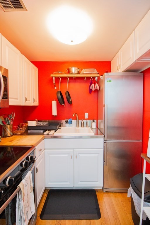 34 Winchester Street, Unit 2 Brookline, MA 02446 - Photo 7 of 14 a view of a kitchen with a sink and cabinets