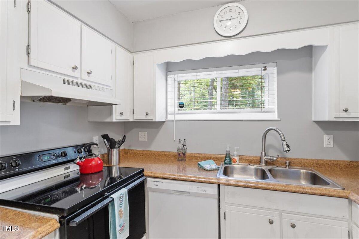 712 Godwin Court Raleigh, NC 27606 - Photo 12 of 27 a kitchen with granite countertop a sink and a stove