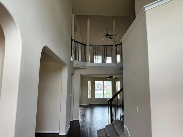 a view of entryway and hall with wooden floor