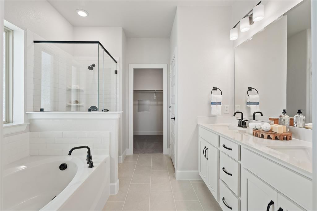 8717 Kentucky Derby Street Pilot Point, TX 76258 - Photo 8 of 18 a bathroom with a tub a sink and mirror