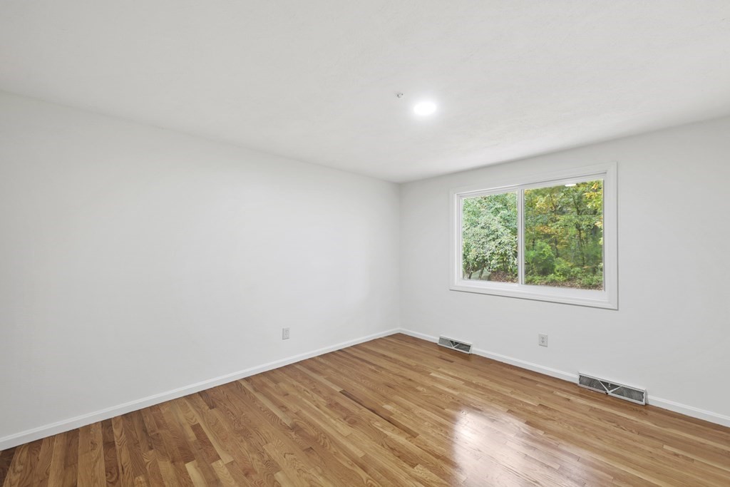 46 Badger Road Framingham, MA 01702 - Photo 21 of 38 a view of empty room with wooden floor and fan