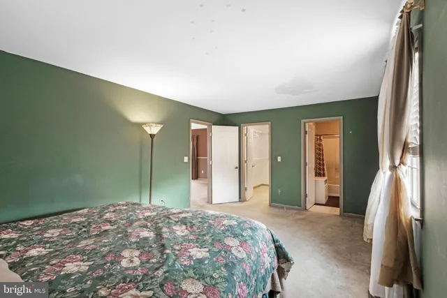 a bedroom with a bed and a large window