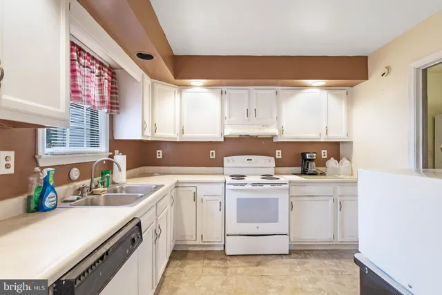a kitchen with a sink stove and cabinets