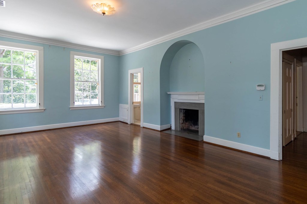 1617 Summit Drive Columbus, GA 31906 - Photo 17 of 35 an empty room with wooden floor fireplace and windows