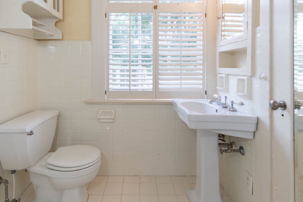 1617 Summit Drive Columbus, GA 31906 - Photo 23 of 35 a bathroom with a sink a toilet and a mirror