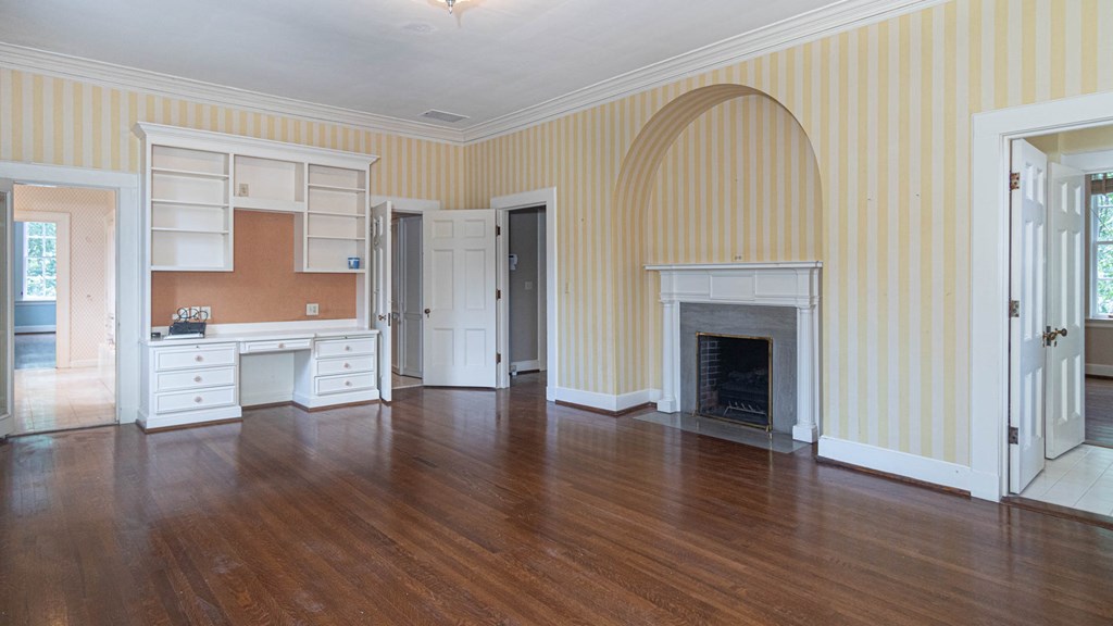 1617 Summit Drive Columbus, GA 31906 - Photo 24 of 35 an empty room with wooden floor and a fireplace