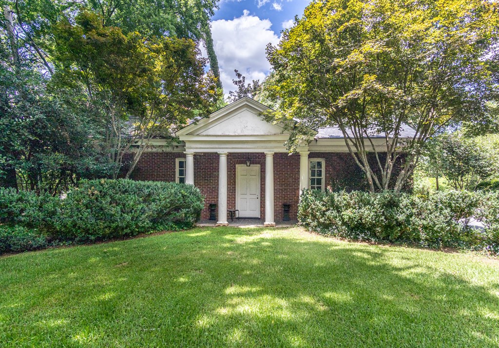 1617 Summit Drive Columbus, GA 31906 - Photo 28 of 35 a front view of a house with a garden and yard