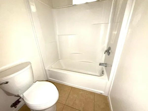 a bathroom with a toilet and a bathtub