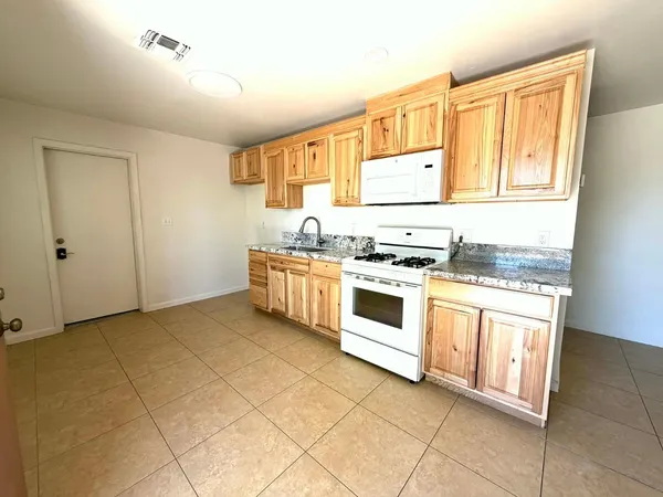 a kitchen with stainless steel appliances granite countertop a stove and a sink