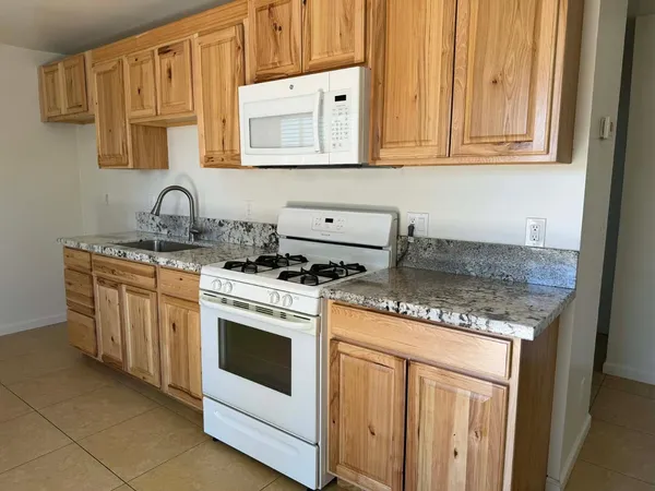 a kitchen with stainless steel appliances granite countertop a stove and a sink