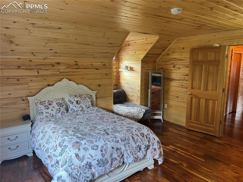 87 Thompson Road Gardner, CO 81040 - Photo 39 of 49 a bedroom with a bed and wooden floor