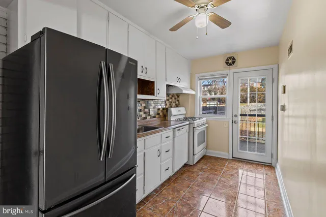 a kitchen with a refrigerator and a sink