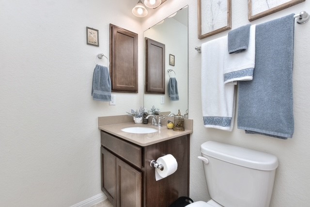 705 Kitty Hawk Road Georgetown, TX 78633 - Photo 18 of 21 a bathroom with a toilet sink and mirror