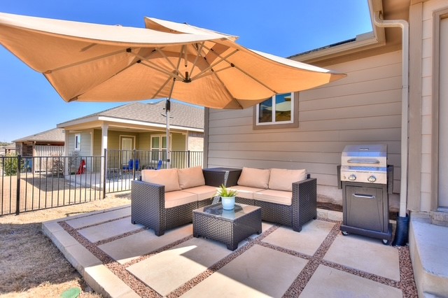 705 Kitty Hawk Road Georgetown, TX 78633 - Photo 19 of 21 a view of a patio with couches table and chairs under an umbrella