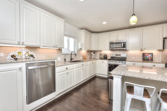 705 Kitty Hawk Road Georgetown, TX 78633 - Photo 8 of 21 a kitchen with granite countertop white cabinets and white appliances