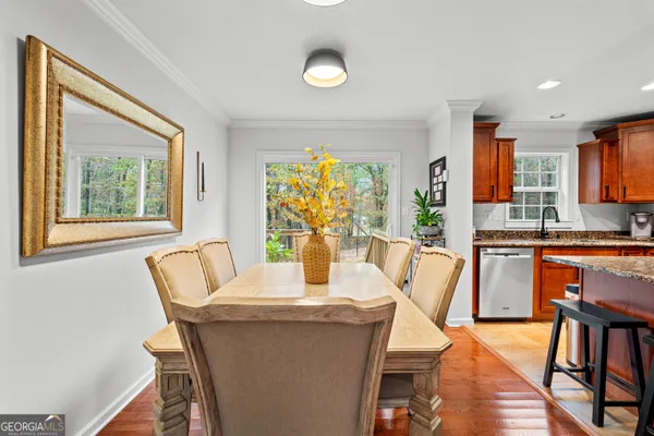 a dining room with furniture and wooden floor