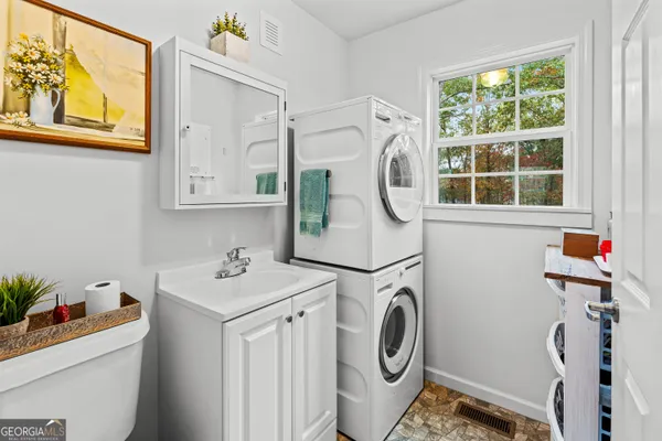 a utility room with dryer washer and a window