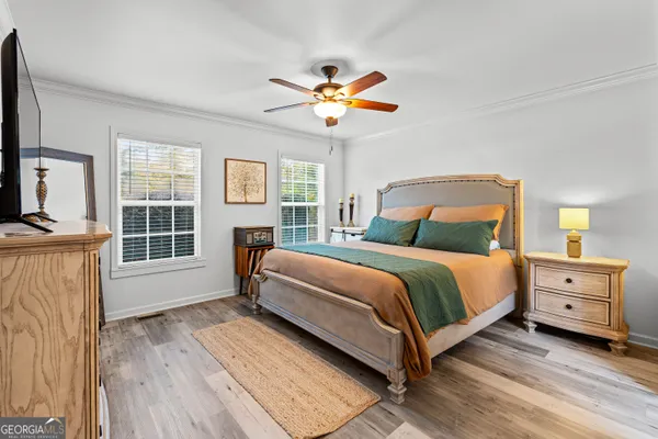 a bedroom with a bed and a chandelier