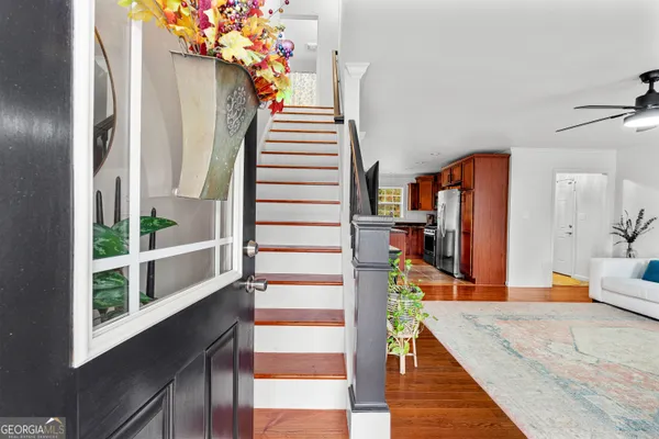 a view of living room kitchen and entryway