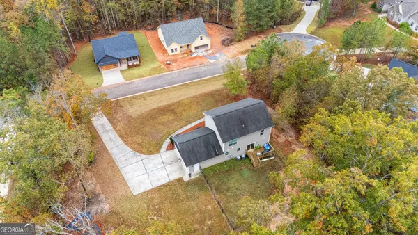 an aerial view of a house with swimming pool and sitting space