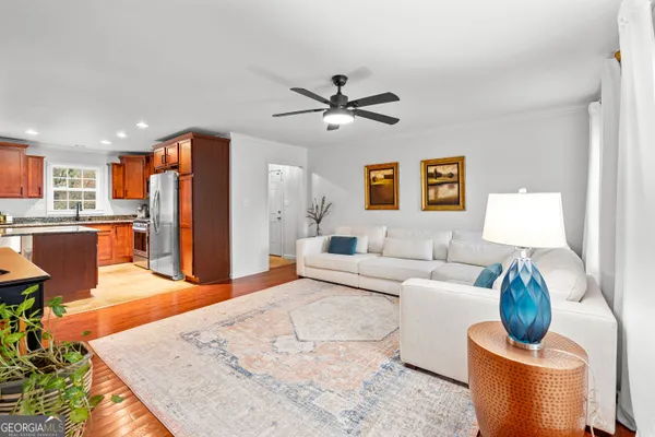 a living room with furniture a refrigerator and a table