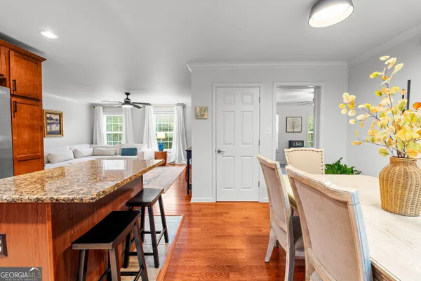 a dining room with furniture and wooden floor