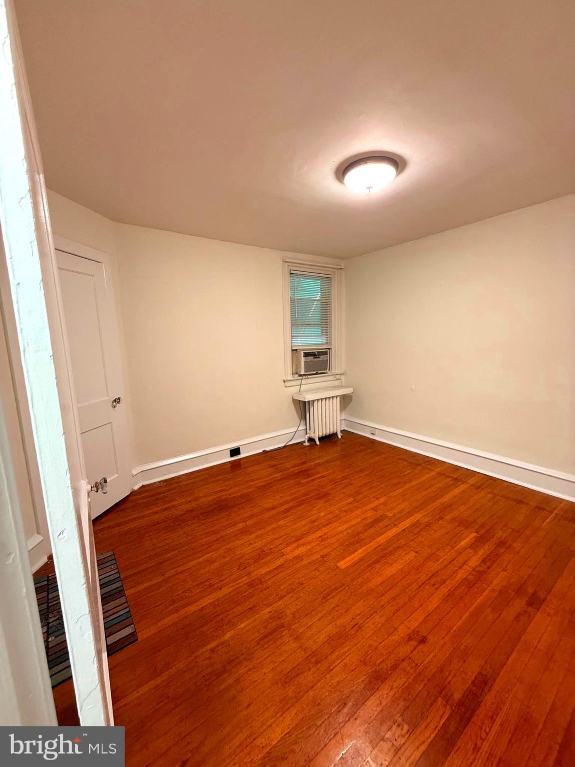 5118 Oakland Street, Unit 2 Philadelphia, PA 19124 - Photo 12 of 36 an empty room with wooden floor and windows