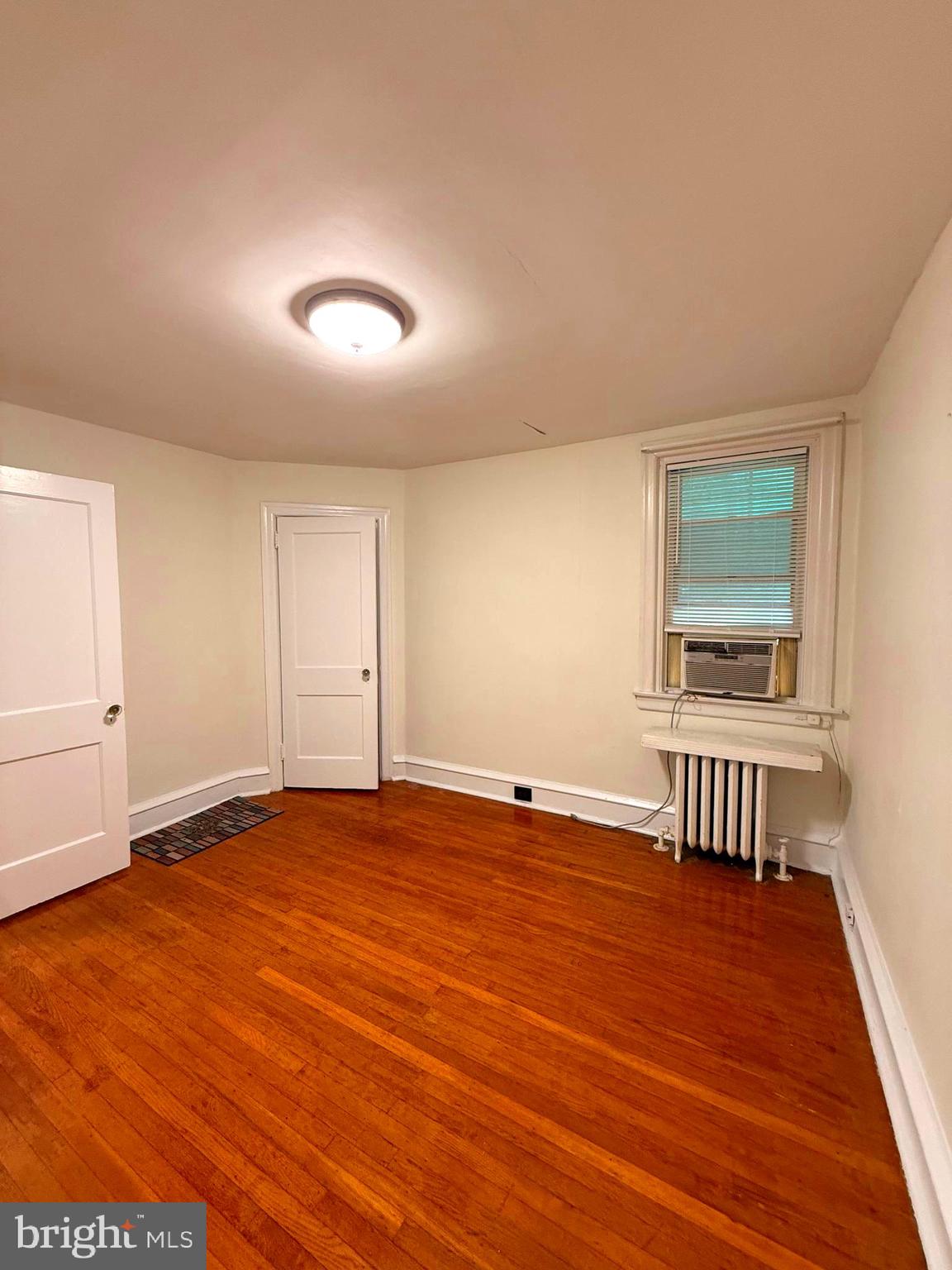 5118 Oakland Street, Unit 2 Philadelphia, PA 19124 - Photo 13 of 36 an empty room with wooden floor and windows