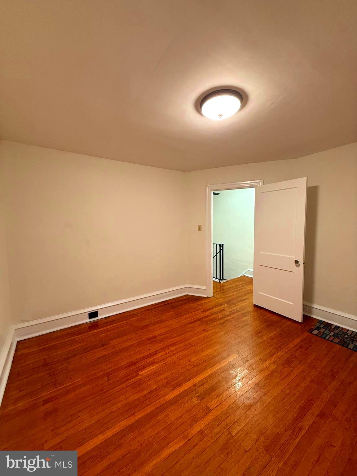 5118 Oakland Street, Unit 2 Philadelphia, PA 19124 - Photo 14 of 36 an empty room with wooden floor and windows