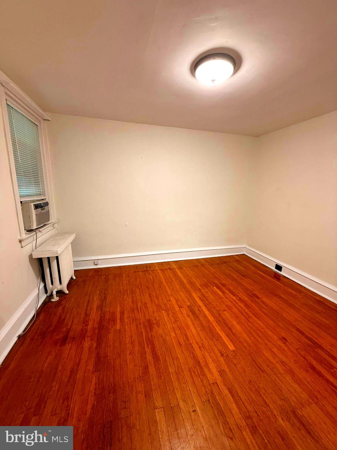 5118 Oakland Street, Unit 2 Philadelphia, PA 19124 - Photo 15 of 36 an empty room with wooden floor and windows