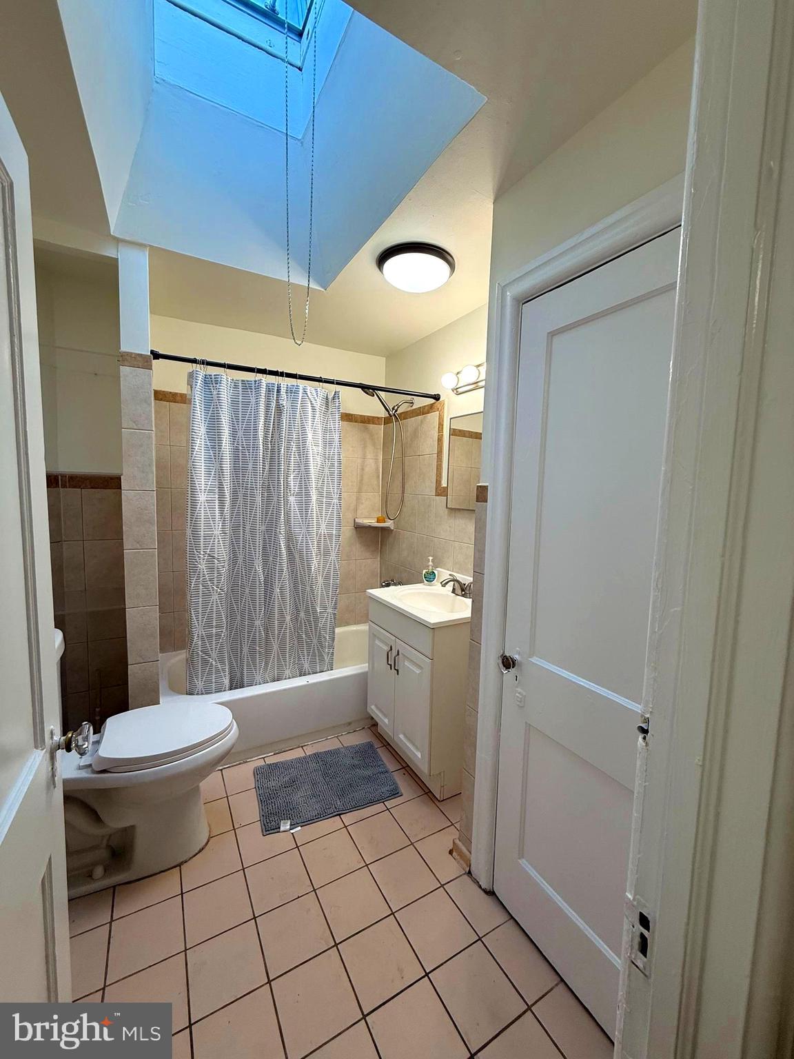 5118 Oakland Street, Unit 2 Philadelphia, PA 19124 - Photo 22 of 36 a bathroom with a sink a toilet a mirror and shower