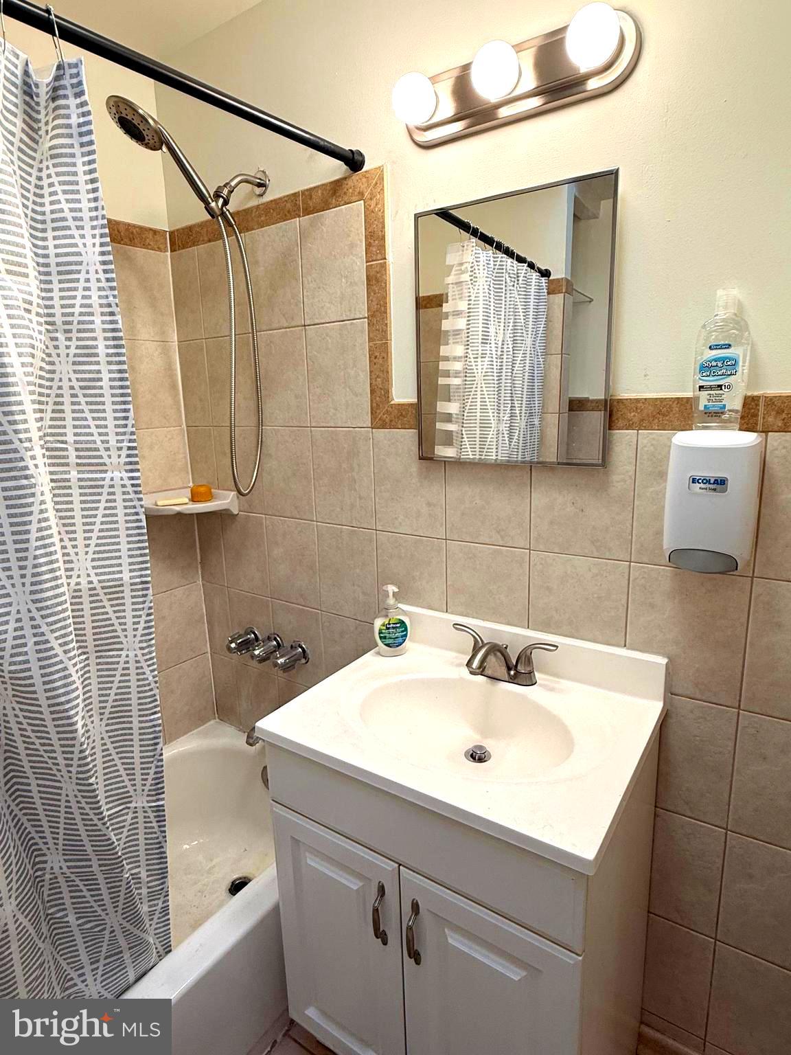 5118 Oakland Street, Unit 2 Philadelphia, PA 19124 - Photo 23 of 36 a bathroom with a sink and a mirror