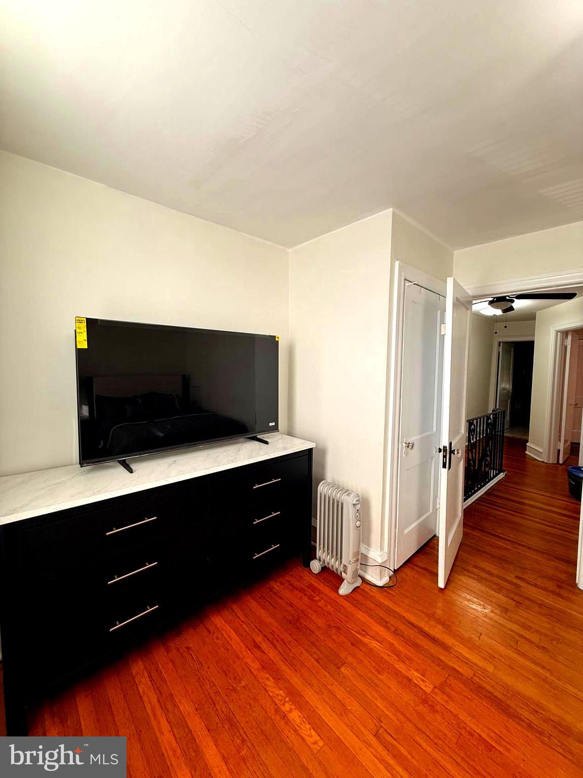 5118 Oakland Street, Unit 2 Philadelphia, PA 19124 - Photo 26 of 36 a living room with hard wood floors and a flat screen tv