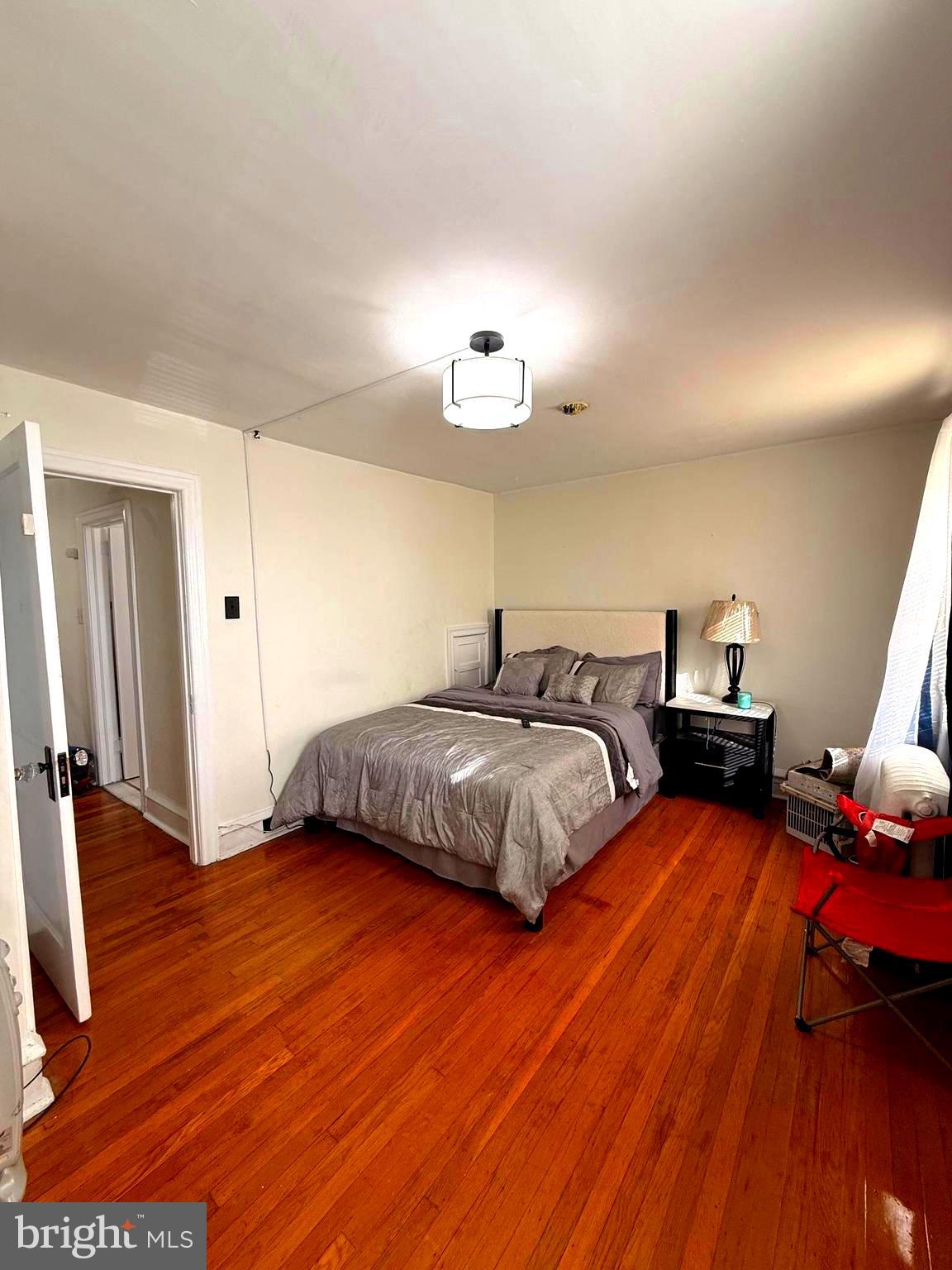 5118 Oakland Street, Unit 2 Philadelphia, PA 19124 - Photo 27 of 36 a bedroom with a bed and wooden floor