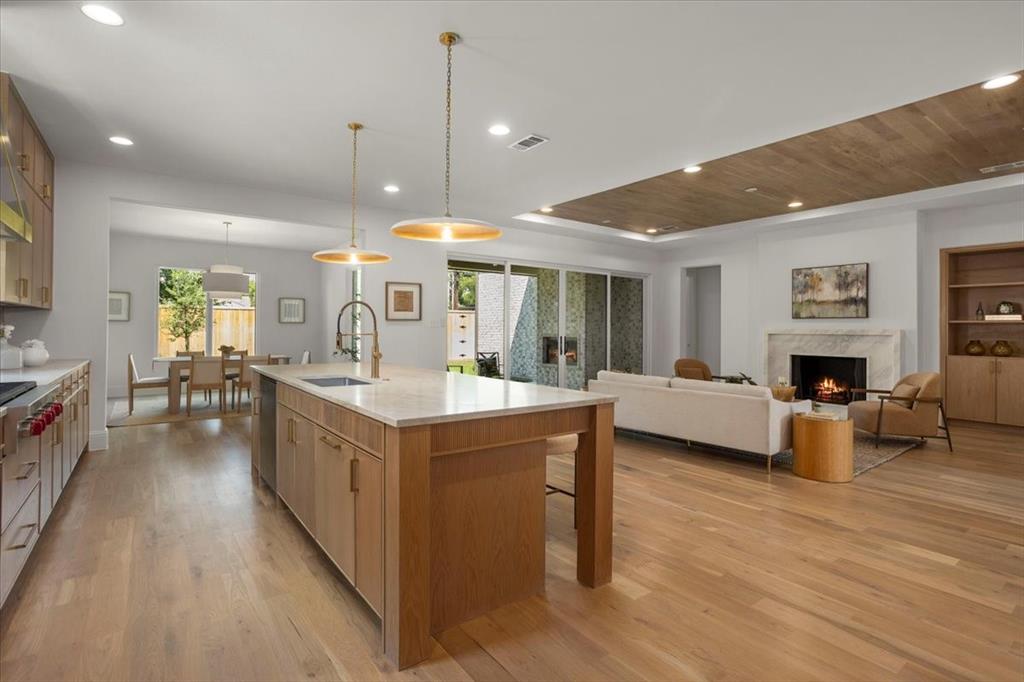 3935 Rochelle Drive Dallas, TX 75220 - Photo 13 of 27 a large white kitchen with sink stove and a wooden floor
