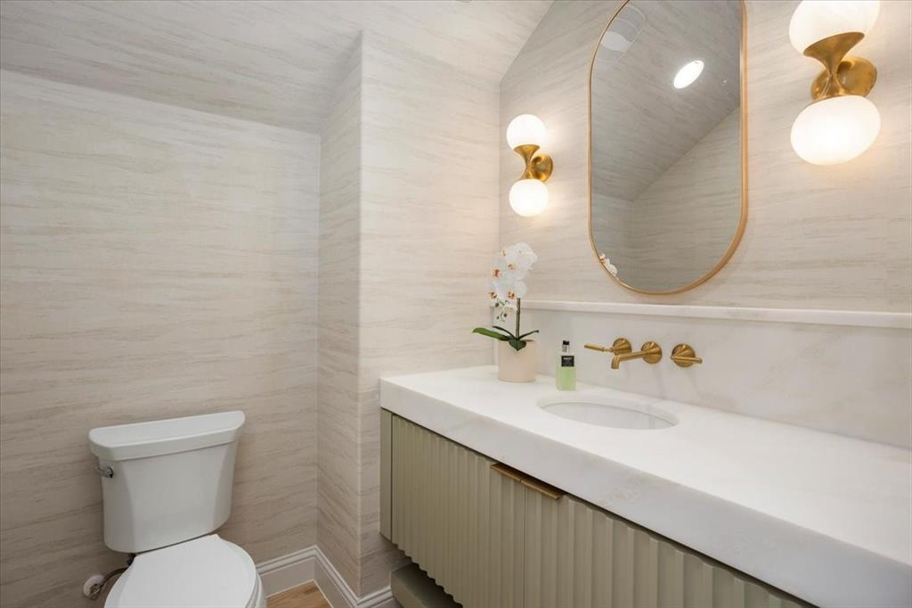 3935 Rochelle Drive Dallas, TX 75220 - Photo 14 of 27 a bathroom with a toilet sink and mirror