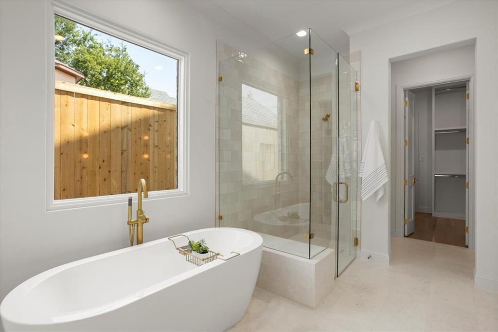 3935 Rochelle Drive Dallas, TX 75220 - Photo 17 of 27 a bathroom with a tub a sink and a shower